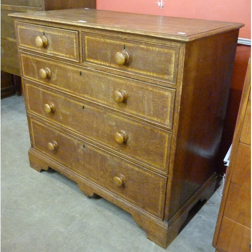 110 - A George III oak featherbanded chest of drawers