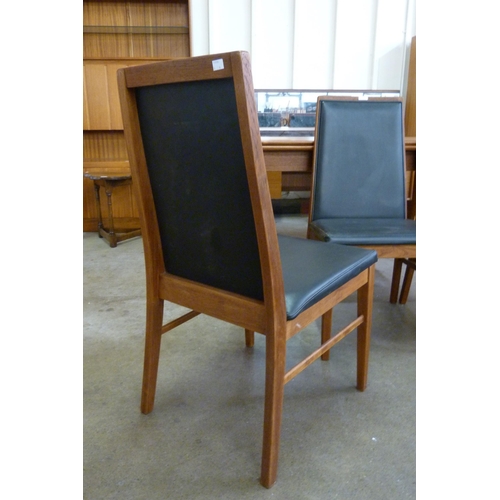 12 - A set of four Danish Dyrlund teak and black vinyl dining chairs