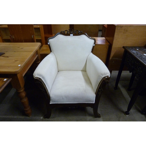 133 - An Edward VII carved oak and fabric upholstered armchair