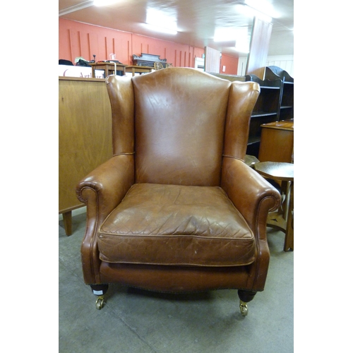 135 - A Laura Ashley Regency style chestnut brown leather wingback armchair