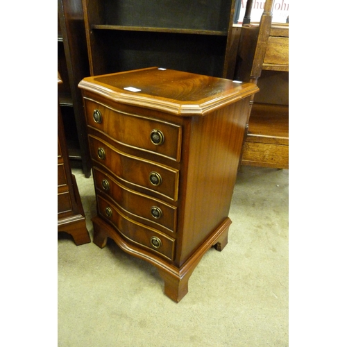 141 - A pair of small mahogany serpentine chests of drawers