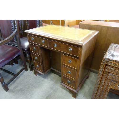 149 - A George I style mahogany and tan leather topped kneehole desk