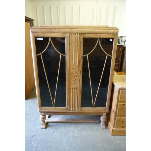 156 - An oak two door bookcase (lacking shelves)