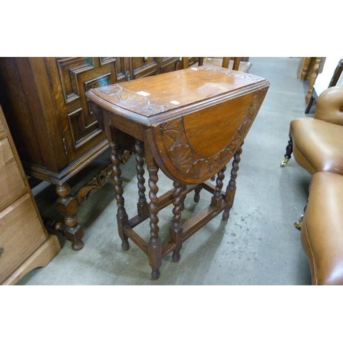 178 - A carved oak gateleg table