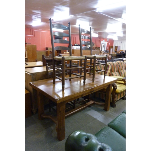 182 - A French elm farmhouse single drawer table and four ladderback chairs