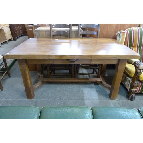 182 - A French elm farmhouse single drawer table and four ladderback chairs