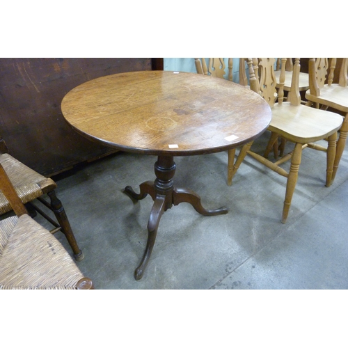 187 - A George III oak circular tilt top tripod tea table