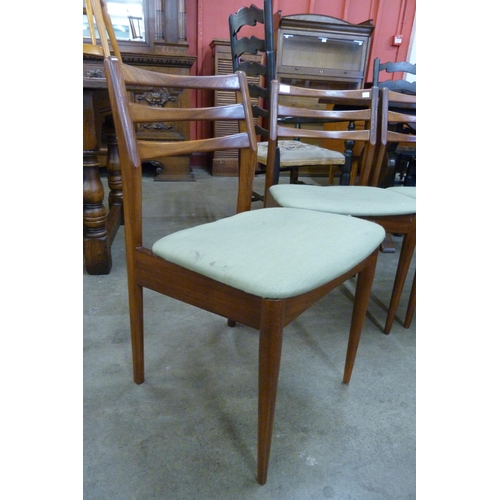 19 - A set of four teak dining chairs