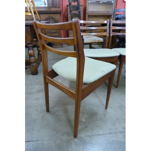 19 - A set of four teak dining chairs