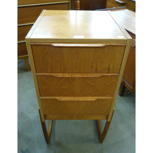 22 - A small teak chest of drawers