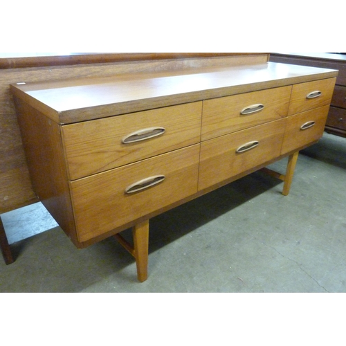 25 - A teak six drawer sideboard