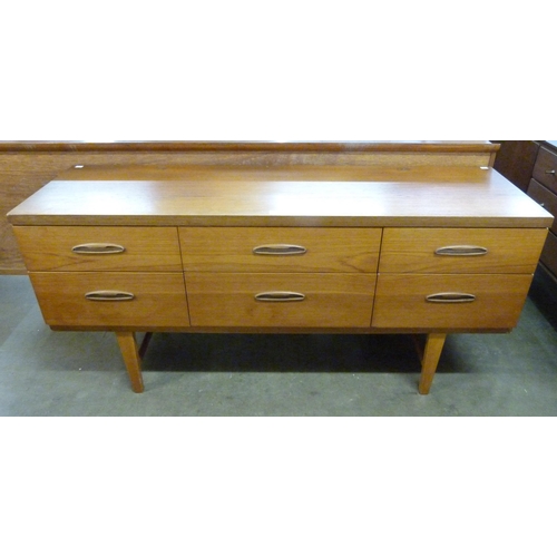 25 - A teak six drawer sideboard