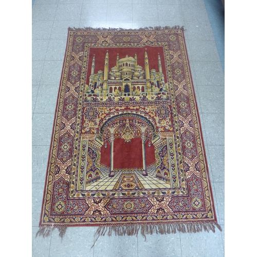 259 - An Indian Taj Mahal pattern red ground wall hanging