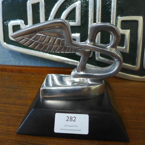 282 - A metal Jaguar sign and a Bentley paperweight