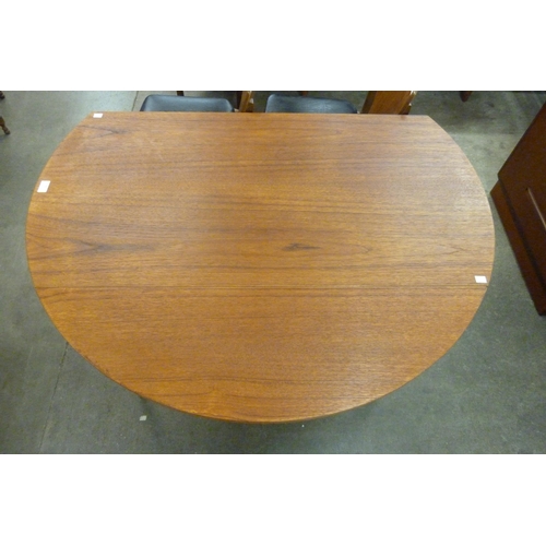 31 - A teak drop-leaf table and four chairs