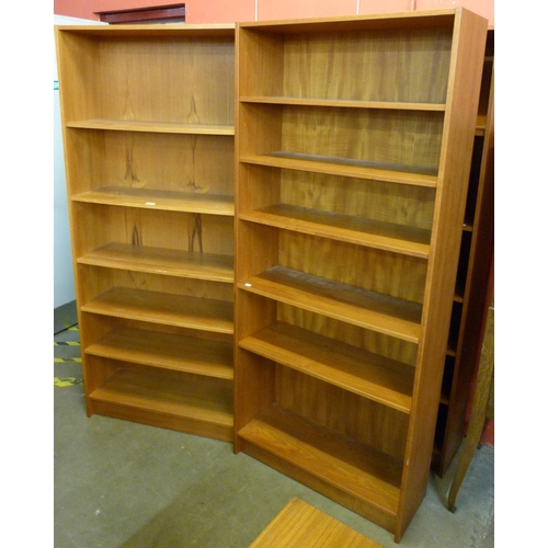 38 - A pair of tall Danish Domino teak open bookcases