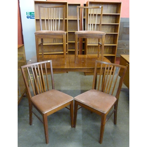 40 - A teak extending dining table and four chairs