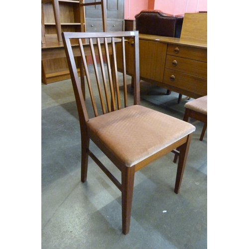 40 - A teak extending dining table and four chairs