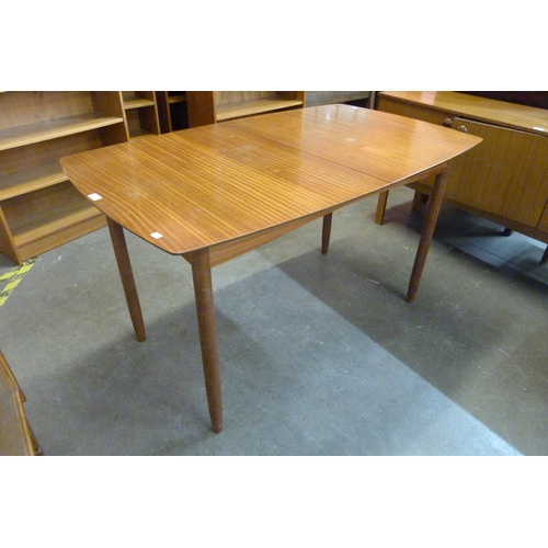 40 - A teak extending dining table and four chairs