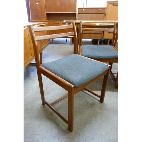 67 - A set of four teak dining chairs, a teak nest of tables and a cheval mirror