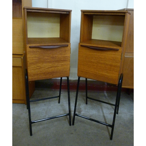 72 - A pair of teak cabinets on black metal stands