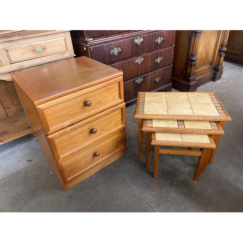 94A - A teak and tiled top nest of tables and a teak bedside chest