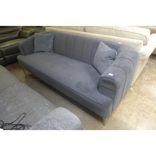 1447 - A grey velvet upholstered shell back three seater sofa