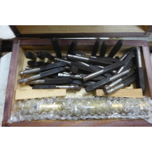 2057 - A full set of letter punches and an eleven piece wood carving set