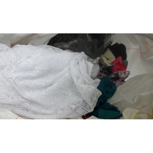 2418 - A large bag of unworn clothing including jackets, t-shirts and dresses etc