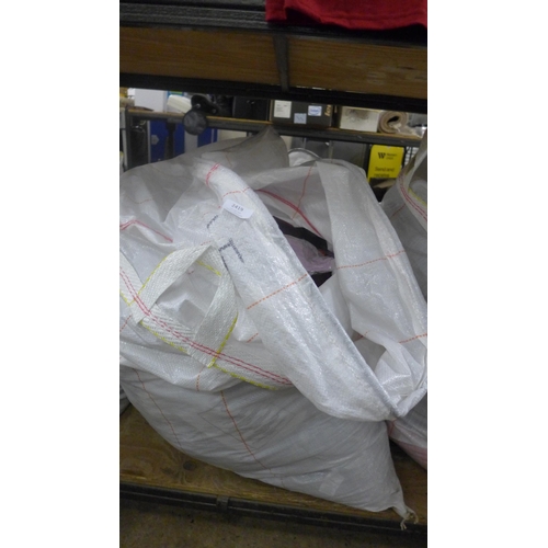 2419 - A large bag of unworn clothing, mostly t-shirts in sealed bags