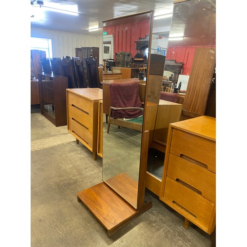 67 - A set of four teak dining chairs, a teak nest of tables and a cheval mirror