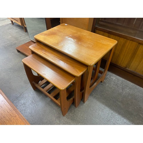 67 - A set of four teak dining chairs, a teak nest of tables and a cheval mirror