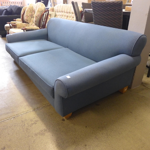 1631 - A large four seater blue upholstered sofa