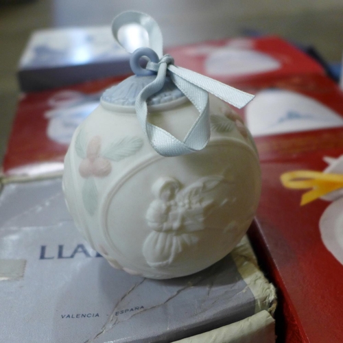 702 - Fourteen Lladro Christmas bells, boxed, etc.