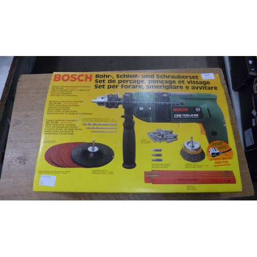 2059 - A Bosch CSB700-2RE hammer drill including disc sander, wire brush, drill and screwdriver attachments... 