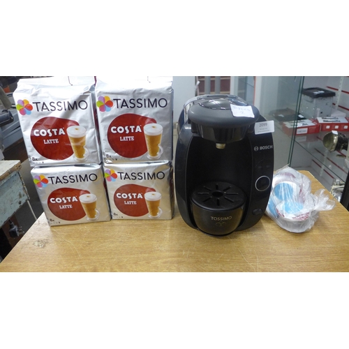 2099 - A Tassimo coffee machine with a quantity of latte coffee pods