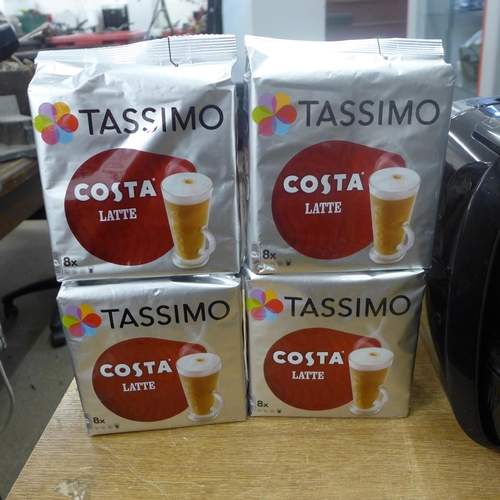 2099 - A Tassimo coffee machine with a quantity of latte coffee pods