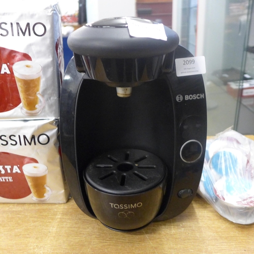 2099 - A Tassimo coffee machine with a quantity of latte coffee pods