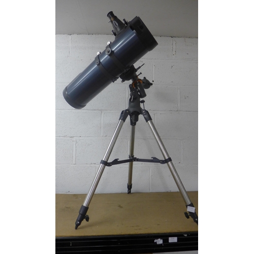 2114 - A Celestron Astromaster 130 telescope on tripod