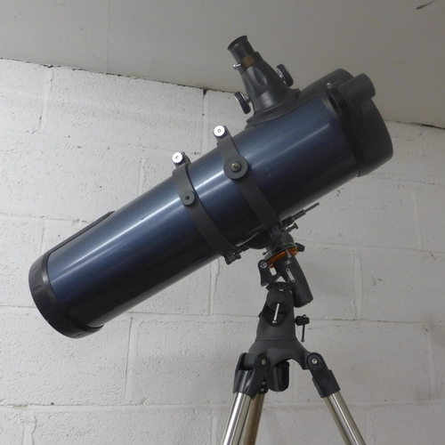 2114 - A Celestron Astromaster 130 telescope on tripod