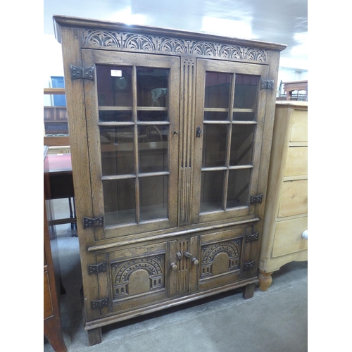 107 - A 17th Century style carved Ipswich oak four door bookcase