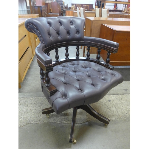 116 - A mahogany and leather revolving Captain's desk chair