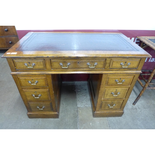 13 - A Victorian oak and brown leather topped pedestal desk