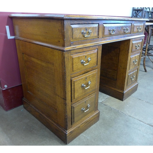 13 - A Victorian oak and brown leather topped pedestal desk