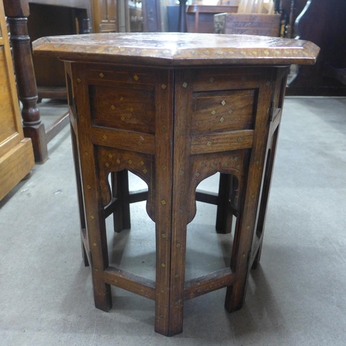 135 - An Indian hardwood and brass inlaid octagonal occasional table