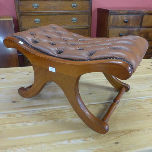 152 - A mahogany and tan leather saddle stool