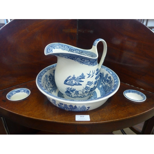 163 - A George III mahogany corner washstand, with blue and white porcelain jug, bowl and soap dishes