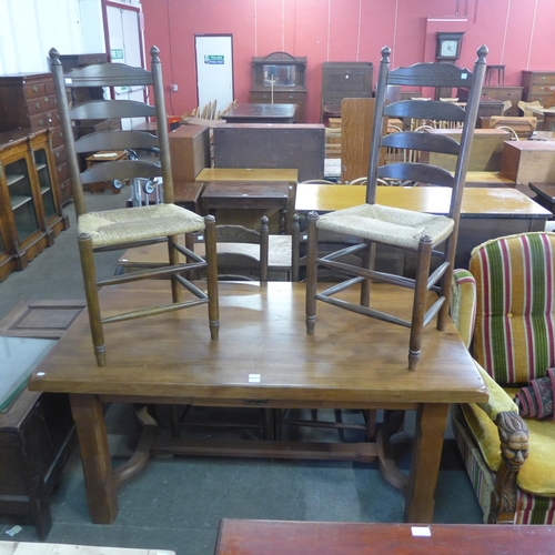 173 - A French elm farmhouse single drawer table and four ladderback chairs