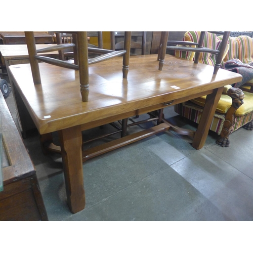 173 - A French elm farmhouse single drawer table and four ladderback chairs