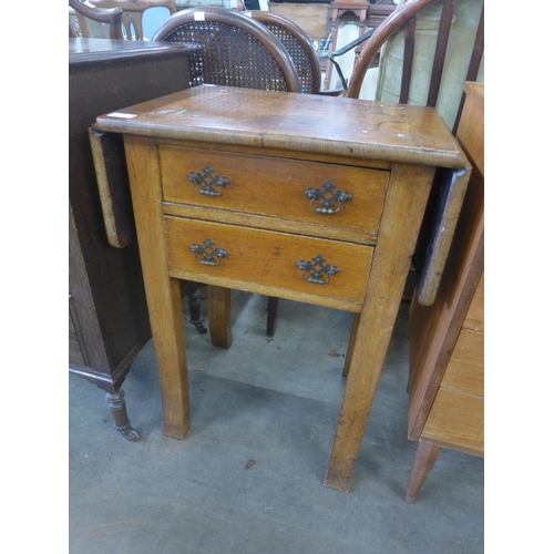 199 - A Victorian oak two drawer drop-leaf side table and an oak barleytwist tripod wine table